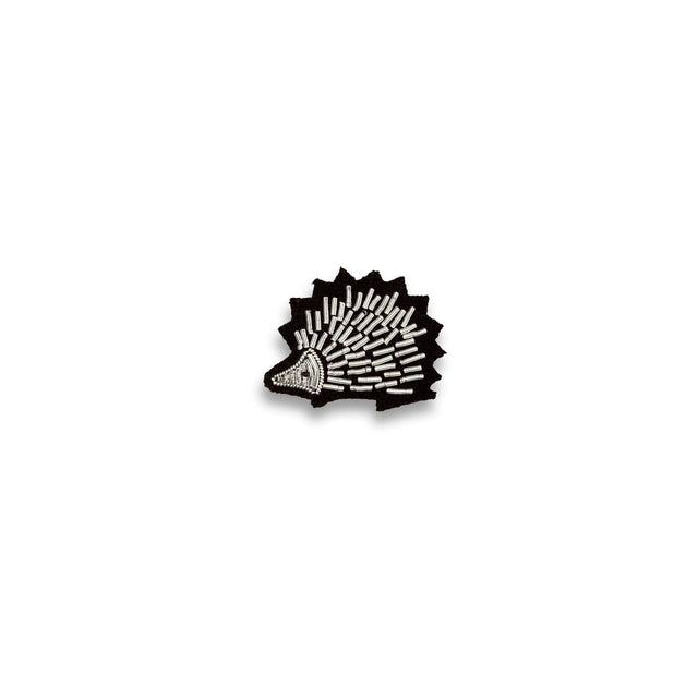 Macon & Lesquoy hedgehog lapel pin hand-embroidered in silver and black thread, photographed on a plain white background