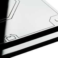 Corner detail of the two-tier acrylic base plate showing the laser-cut edge and vector frame line