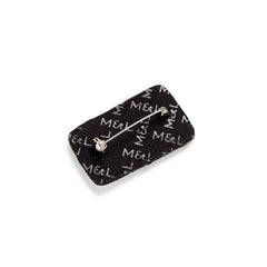 Reverse of the sardine tin brooch showing the felt backing and pin fastening