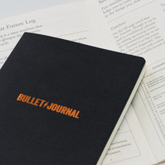 Detachable Bullet Journal pocket guide resting on an open Bullet Journal Edition 2