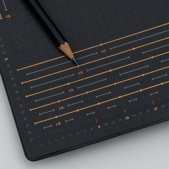 Grid guide printed inside the black cover of the Bullet Journal Edition 2, with a pencil resting on it