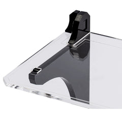 Close-up of a clear acrylic shelf seated on a gloss black support stem