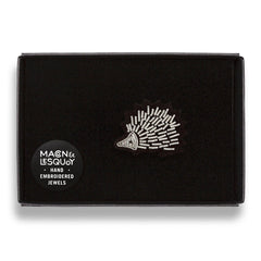 The hedgehog brooch presented inside the maker's black card and velvet gift box