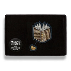 The open book brooch presented inside the maker's black card and velvet gift box