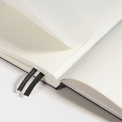 Thread-bound LEUCHTTURM1917 notebook opening flat, showing the two black page markers and gusseted rear pocket